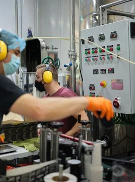 Workers wit covid mask working in a craft beer packaging factory Stock Photos