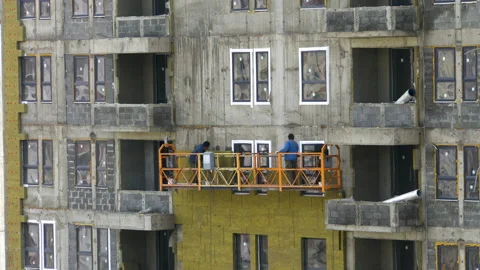Workers work against the wall of the house 4K Stock Footage 154003822