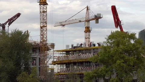 Workers work at construction site with crane, concrete pump and reinforced co Stock Footage 160416132