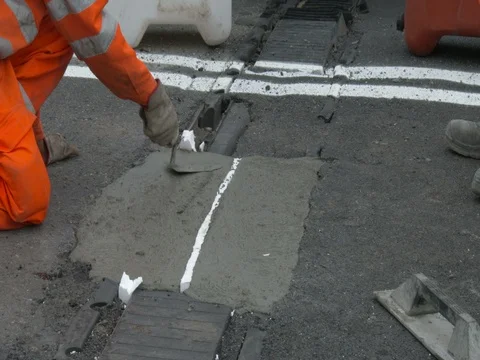 Workers at work on the road, repairing an expansion joint on a bridge, Video stock 83527156