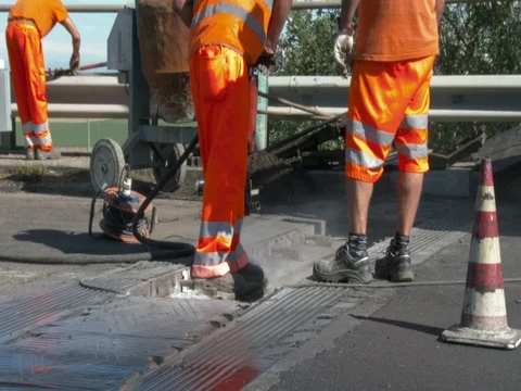 Workers at work on the road, repairing an expansion joint on a bridge, Video stock 83569238
