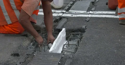 Workers at work on the road, repairing an expansion joint on a bridge, Video stock 83599536