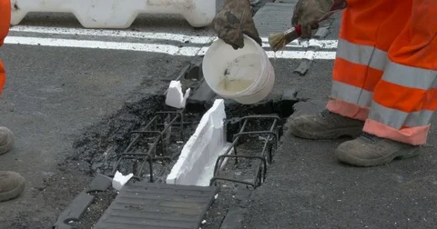 Workers at work on the road, repairing an expansion joint on a bridge, Video stock 83607582