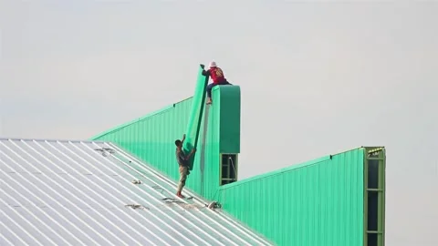 Workers work on the roof of the hall Stock Footage 312912545