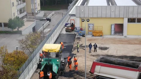Workers working on asphalting a parking lot Stock Footage 144367246
