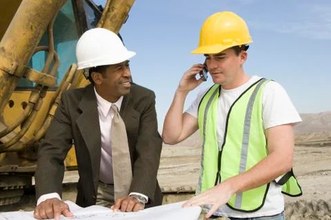 Workers Working At Construction Site Stock Photos