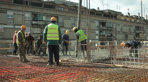 Workers working on construction site,one laborer pulling big hose for concreting Stock Footage 47314791