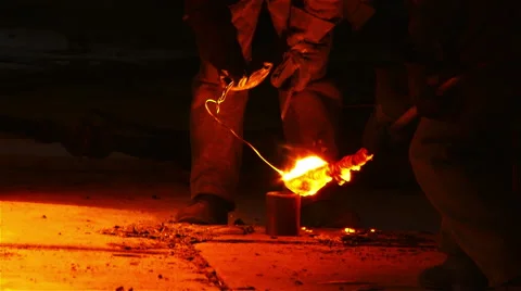 Workers working on melted iron.  Stock Footage 54898423