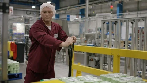 Workers working on production line and carrying packed cosmetic boxes on trolley Stock Footage 107961908