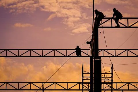 Workers working at twilight Stock Photos