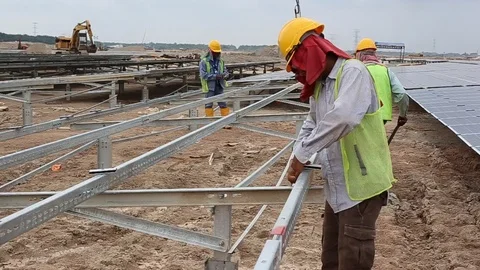Workes doing works at the large scale of solar farm Stock-Footage 96022035