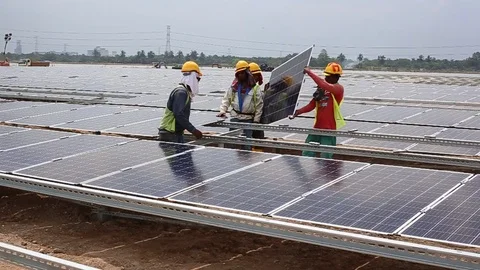Workes doing works at the large scale of solar farm Stock Footage 96023217