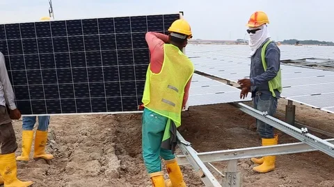 Workes doing works at the large scale of solar farm Stock Footage 96024105