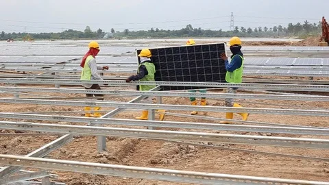 Workes doing works at the large scale of solar farm Stock Footage 96024330