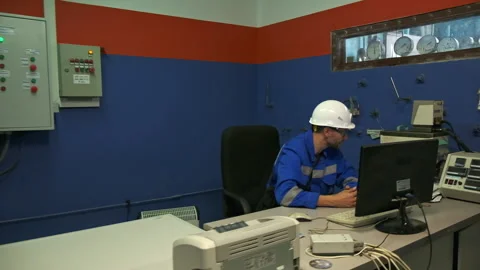 The workflow at the computer. Clip. A sedentary man in a uniform who works in a Stock Footage 242480658
