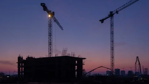 Workflow at the construction site and pouring concrete structures during sunset Stock Footage 255606217