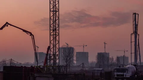 Workflow at the construction site and pouring concrete structures during sunset Stock Footage 255606275