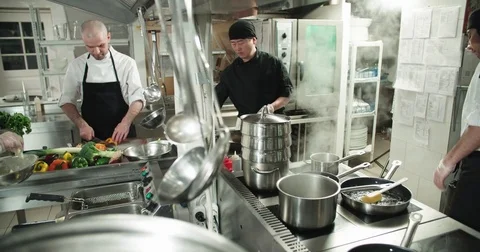 The workflow in the kitchen of the restaurant,a team of Asian chefs prepare Stock Footage 77300128