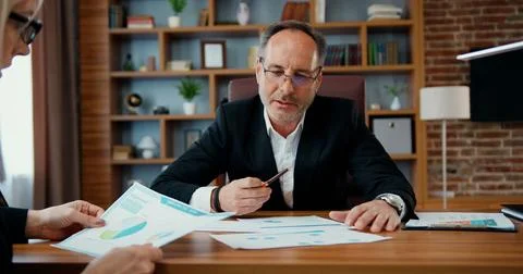 Workflow in office where attractive confident skilled bearded businessman Stock Photos