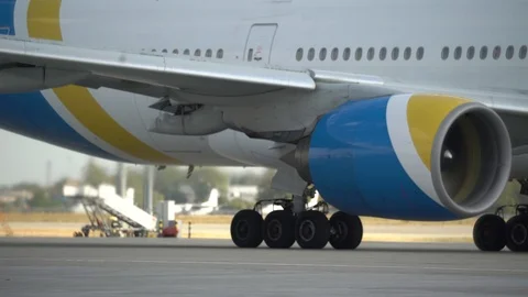 Working airplane engine of the standing aircraft on the airfield. 4K Stock Footage 117176834