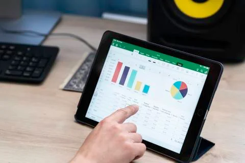 Working and analyzing financial figures on a digital tablet Stock Photos