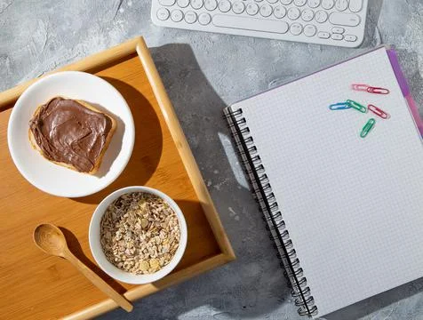 Working and studying during breakfast with sandwich and muesli Stock Photos