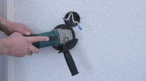 Working with an angle grinder while installing the socket Stock Photos