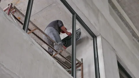 Working Attaching A Fire Shutter Motor Gear Box to a Wall - 4K Stock Footage 51252326