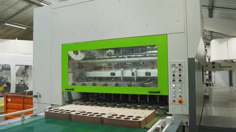 Working automatic machine in cardboard factory releases folded boxes for Stock Footage 280120355