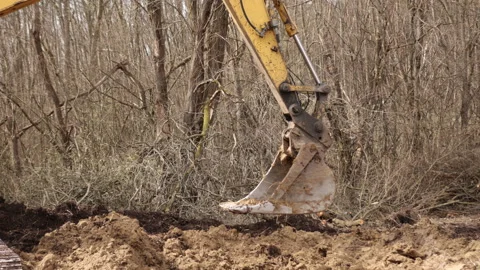 Working backhoe by digging ground at construction site. Excavator bucket teeth 스톡 동영상 198380765