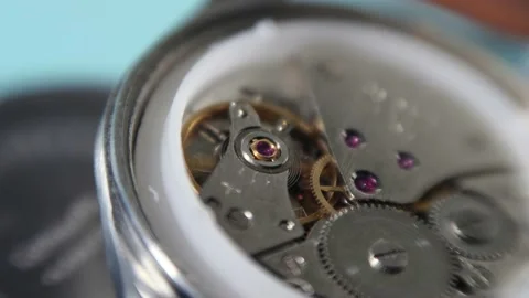 Working balance wheel, spring, and gears of a mechanical wind watch, closeup 4K Stock Footage 165777769