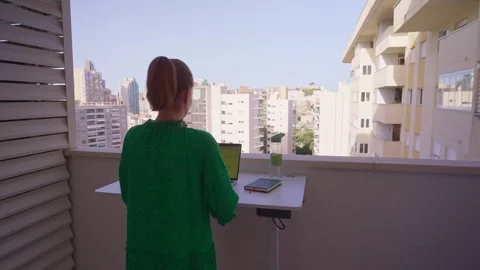 Working on a balcony in a city with a nice view of the buildings and sky during  Stock Footage 338166823