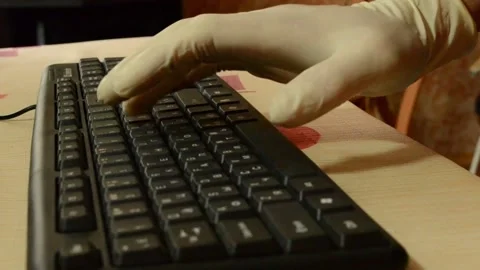 Working on a black keyboard with rubber gloves,a pandemic. Stock Footage 141241449