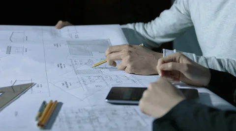 Working on a blueprint: architect studio, designer, project team Stock-Footage 49773894