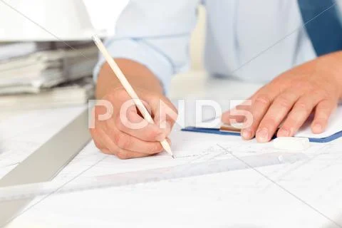 Working on blueprints and construction plans Stock Photos