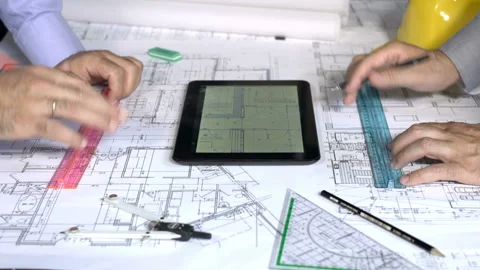 Working on Blueprints and Tablet Stock Footage 210502330