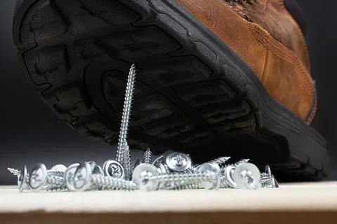 Working boot with screws concept. Stock Photos