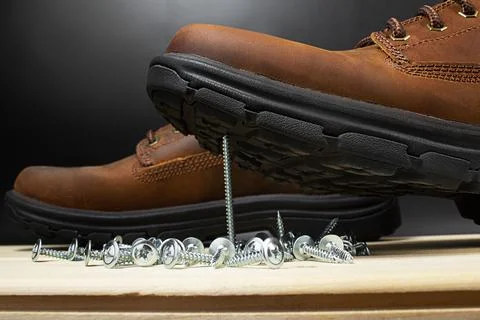Working boots with screws concept. Stock Photos