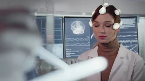 Working on brainwave scanning headset. Woman wearing sensors Stock Footage 149771940