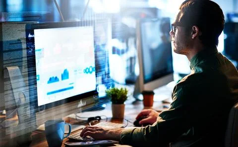 Working on brand new code. Cropped shot of a male computer programmer working on 写真素材