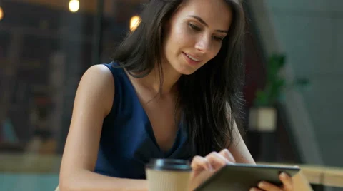 Working at the cafe. Young beautiful long hair woman sitting at the table and Stock Footage 68598683