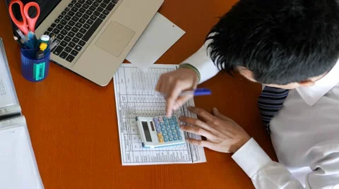 Working to the calculator to count Stock Footage 60695109