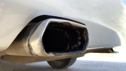 A working car muffler closeup. Macro video of a vibrating car exhaust system. CO Stock Footage 126084073