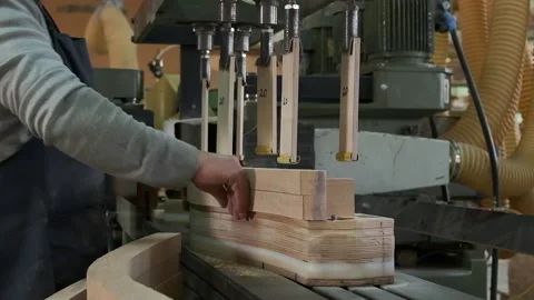 A working carpenter handles a large grinding machine for processing wooden .. Stock Footage 233487122