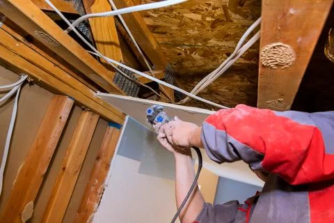 Working on ceiling repair in home with tools materials in garage Stock Photos