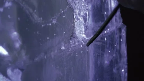 Working with a chisel and hammer on an ice sculpture, artist, 4k Stock Footage 153587805