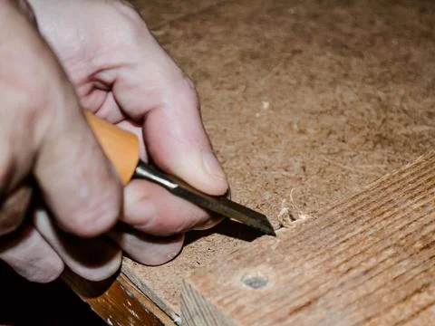 Working with a chisel on wood,the skill of the carpenter. Stock Photos