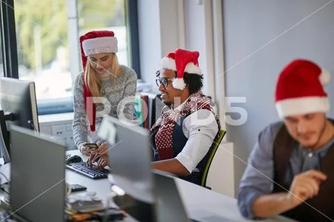 Working at Christmas at office. People work in company in xmas. Stock Photos