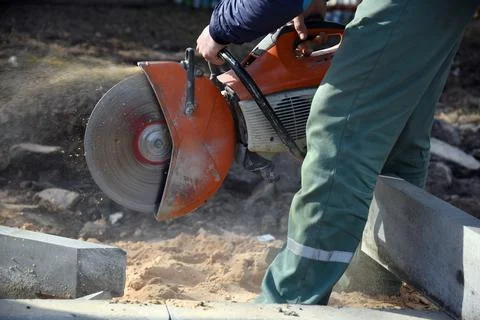 Working circular saw in the hands of a builder. Stock Photos