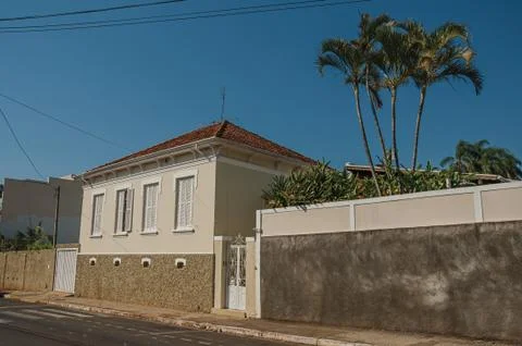 Working-class house with wall in an empty street on a sunny day at São Manuel. Stock Photos